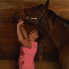 Sarah administers the horse's vitamins and supplements every day to ensure health and performance. Feb. 2015, Gulfstream Racetrack. Photo by: Laura O'Callaghan