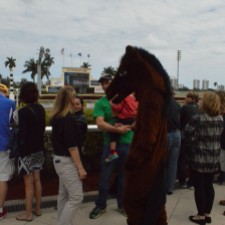 A mascot entertains the kids at the track while waiting for the races to begin. Feb. 2015, Gulfstream Racetrack. Photo by: Laura O'Callaghan